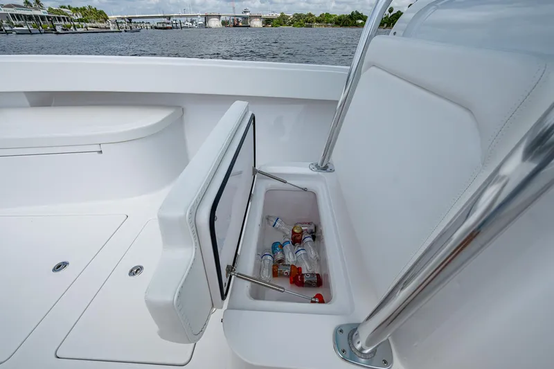 Slide: The Image of 2015 Bahama 41 boat with open storage compartment containing drinks, dockside view. - 8
