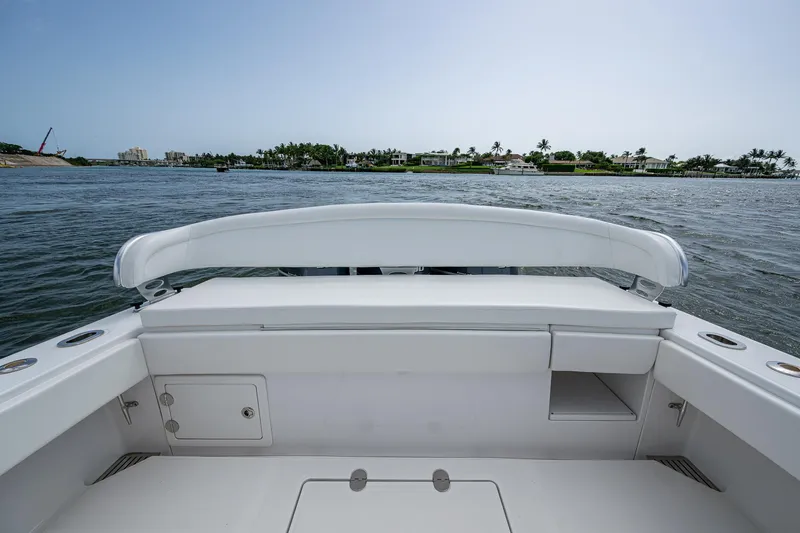 Slide: The Image of 2015 Bahama 41 boat with spacious deck, overlooking calm waters and distant shoreline. - 9