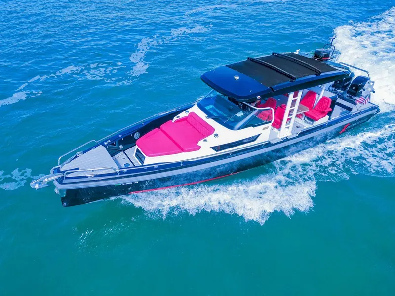 The Image of 2018 Axopar 37 Sun Top boat cruising on blue water with red seating. - 1
