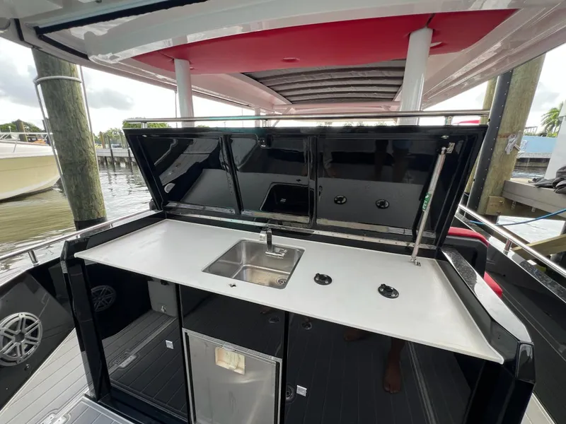 Slide: The Image of 2018 Axopar 37 Sun Top boat with outdoor kitchenette and sink. - 15