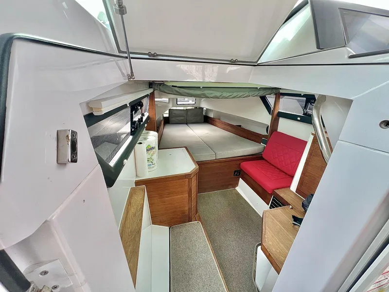 Slide: The Image of 2018 Axopar 37 Sun Top cabin interior with seating and sleeping area. - 21