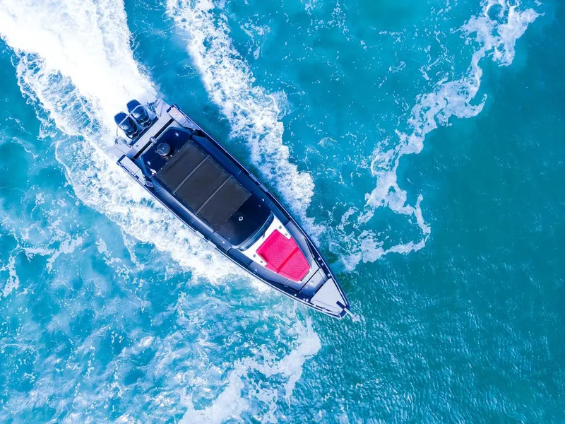 Slide: The Image of Aerial view of 2018 Axopar 37 Sun Top cruising on vibrant blue ocean waters. - 4