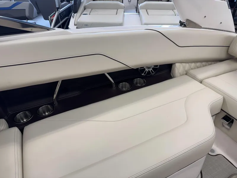 Slide: The Image of Luxurious seating on 2025 Regal LS4 boat with cup holders and sleek design. - 11