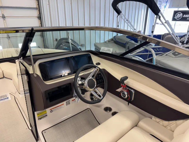 Slide: The Image of 2025 Regal LS4 boat interior with steering wheel and dashboard in showroom. - 14