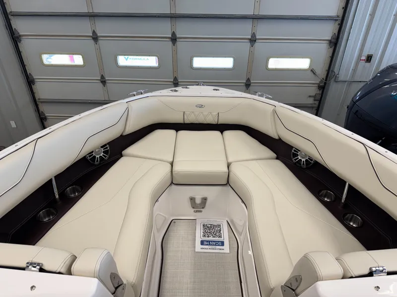 Slide: The Image of 2025 Regal LS4 boat interior with white leather seating in a garage setting. - 15