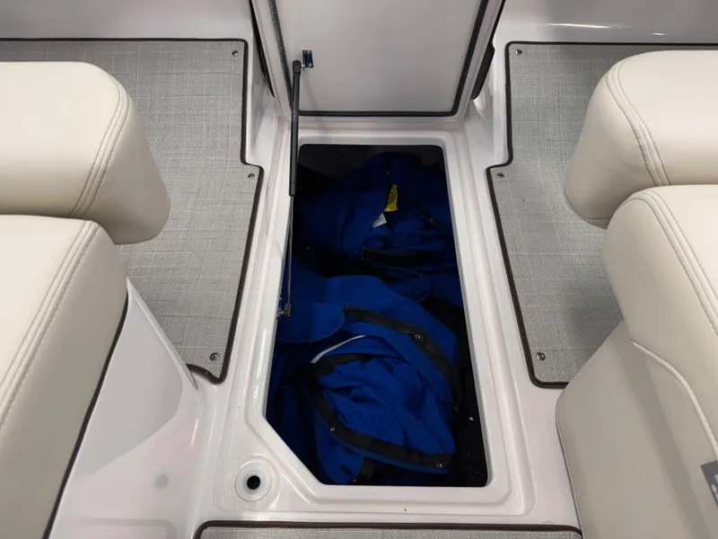 Slide: The Image of 2025 Regal LS4 boat interior storage compartment with blue gear inside. - 19