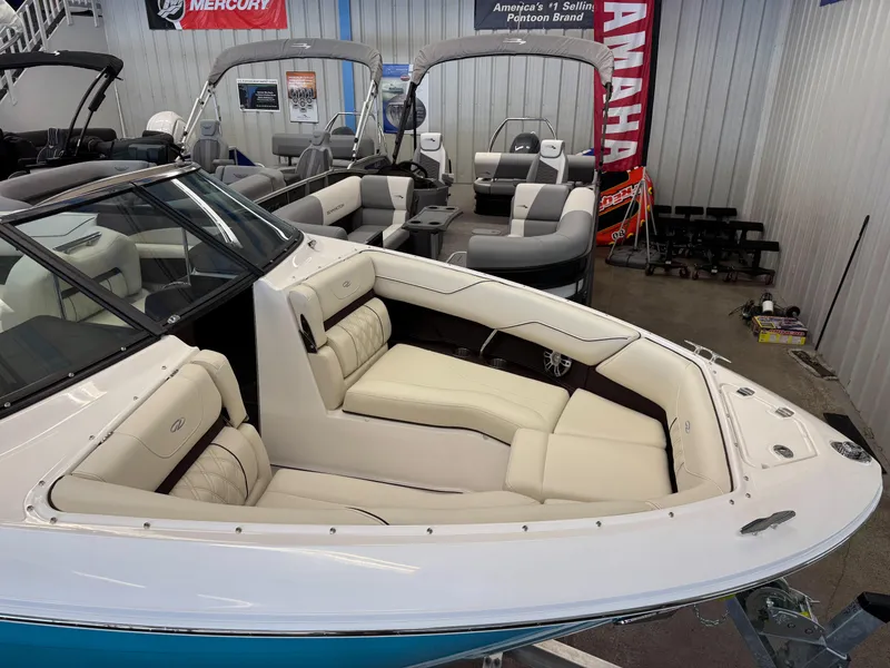 Slide: The Image of 2025 Regal LS4 boat with luxurious seating in a showroom. - 3