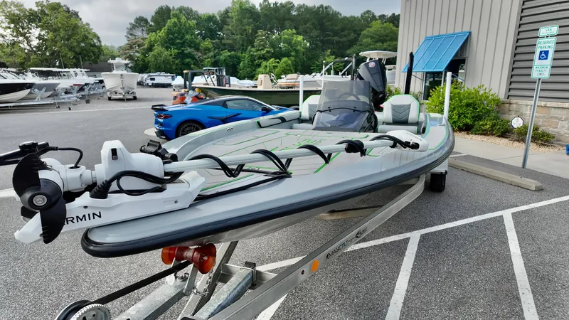 Slide: The Image of 2025 ALK2 Powerboats 21 BHX on trailer, parked outdoors near other vehicles. - 14