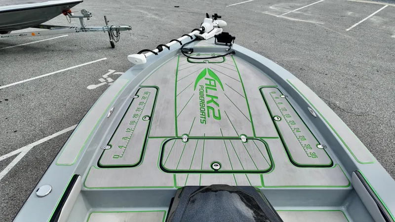 Slide: The Image of 2025 ALK2 Powerboats 21 BHX, sleek design, parked on asphalt, featuring green accents. - 15