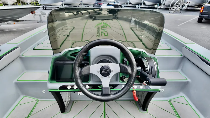 Slide: The Image of 2025 ALK2 Powerboats 21 BHX dashboard with steering wheel and controls, featuring sleek design. - 18
