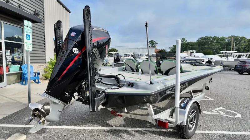 Slide: The Image of 2025 ALK2 Powerboats 21 BHX on trailer, parked outside a marine dealership. - 2