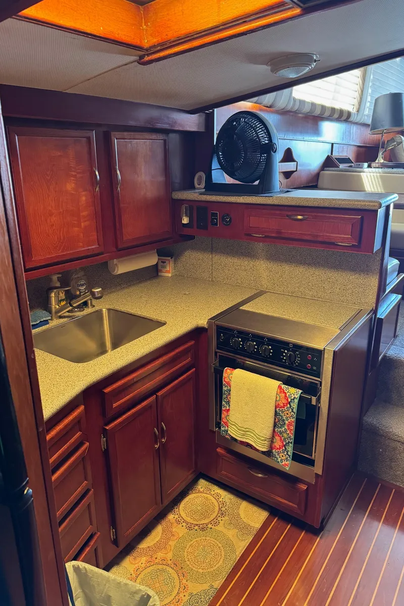 Slide: The Image of 1982 Viking 46 Convertible yacht kitchen with wooden cabinets and modern appliances. - 11