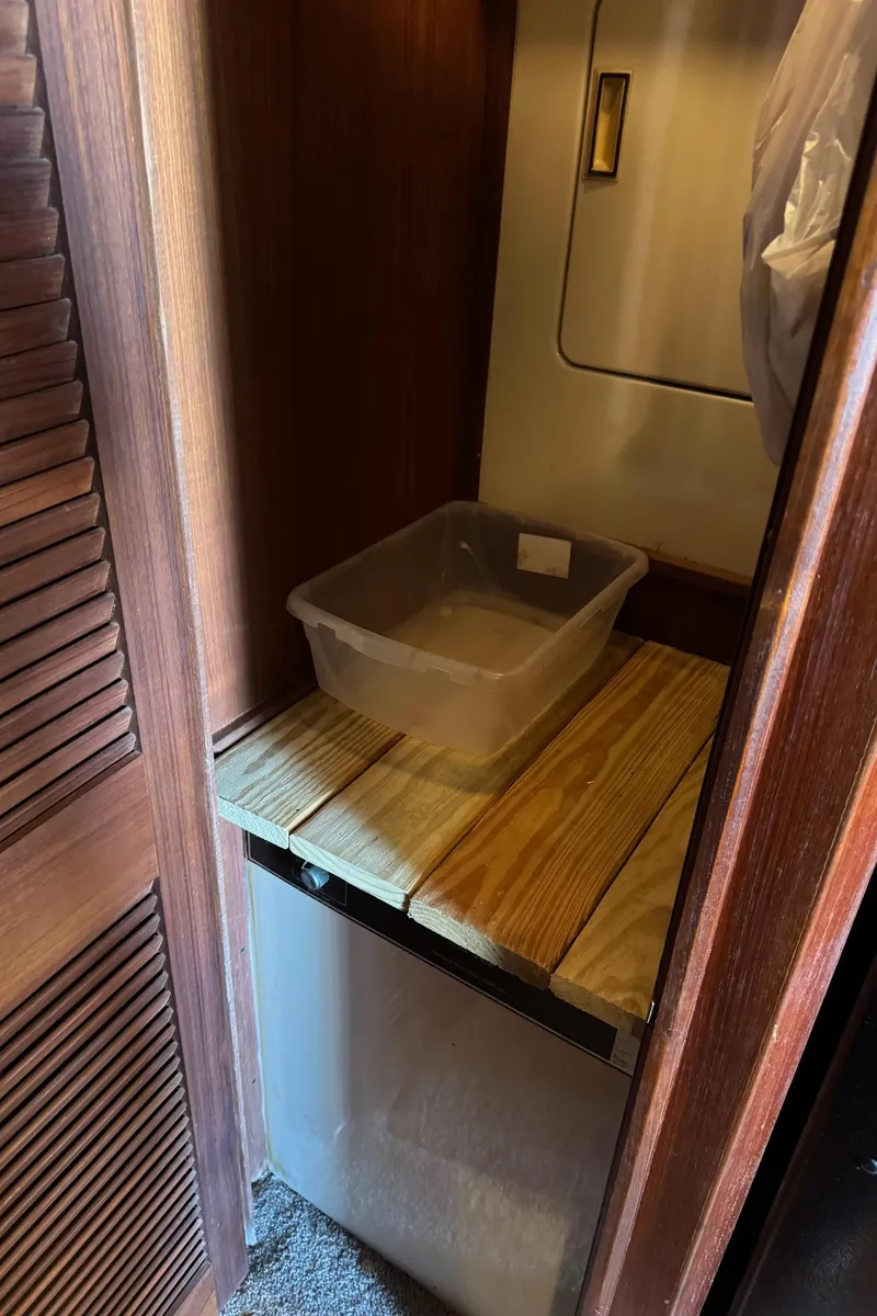 Slide: The Image of Wooden cabinet interior with plastic container, Viking 46 Convertible, 1982 model. - 19