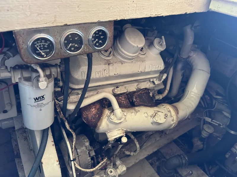 Slide: The Image of Engine compartment of a 1982 Viking 46 Convertible boat with gauges and pipes. - 21