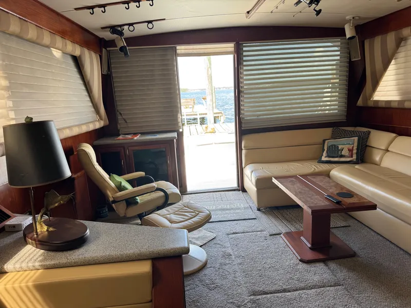 Slide: The Image of Interior of a 1982 Viking 46 Convertible yacht with beige seating and wooden accents. - 6