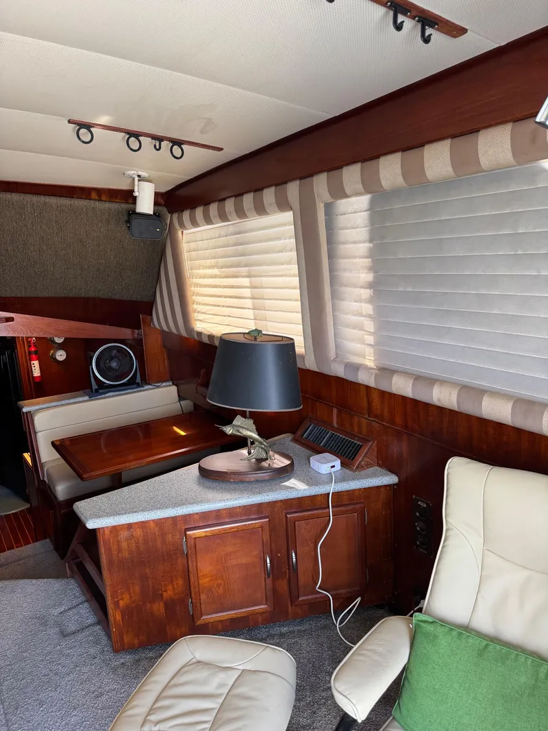 Slide: The Image of Interior of 1982 Viking 46 Convertible yacht with wood paneling and comfortable seating. - 8