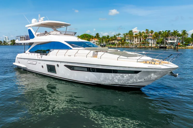 Slide: The Image of 2021 Azimut Fly 72 yacht cruising on a sunny day near palm-lined shore. - 10