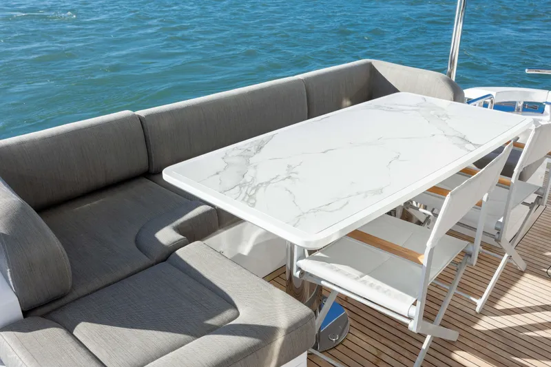 Slide: The Image of Luxury seating area on 2021 Azimut Fly 72 yacht with marble table and ocean view. - 21