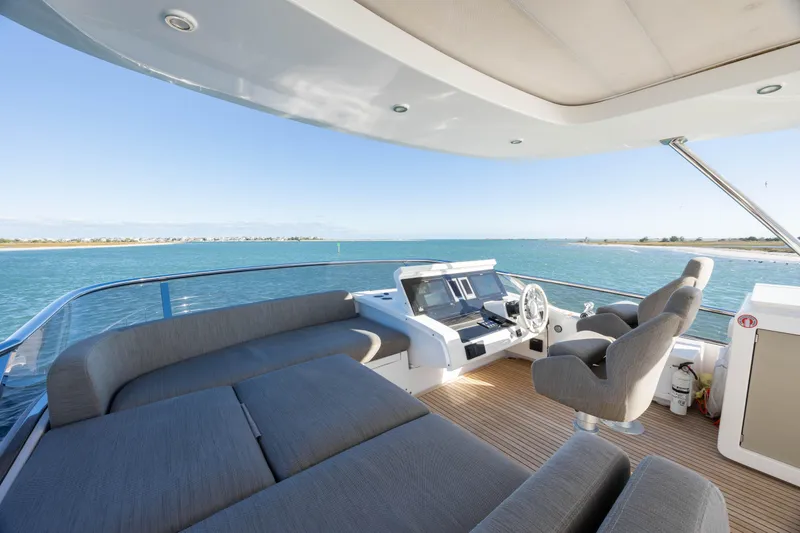 Slide: The Image of Flybridge view of 2021 Azimut Fly 72 yacht with ocean backdrop. - 28