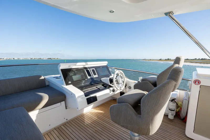Slide: The Image of Flybridge of 2021 Azimut Fly 72 yacht with modern controls and ocean view. - 31