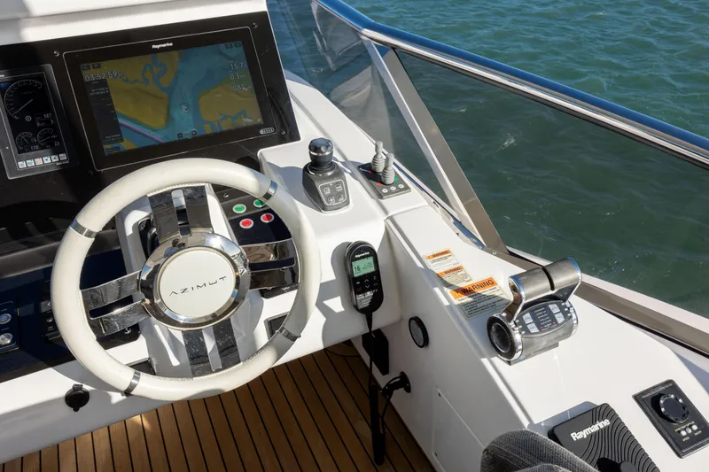 Slide: The Image of Cockpit of 2021 Azimut Fly 72 yacht with navigation controls and steering wheel. - 32