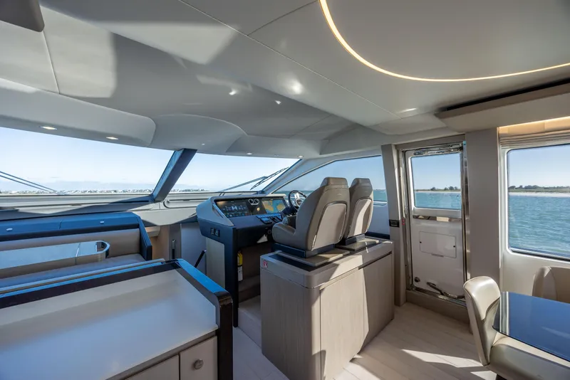 Slide: The Image of Interior of 2021 Azimut Fly 72 yacht, featuring modern helm and panoramic windows. - 49
