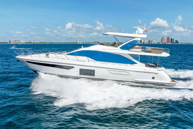 Slide: The Image of 2021 Azimut Fly 72 yacht cruising on open water, city skyline in background. - 5