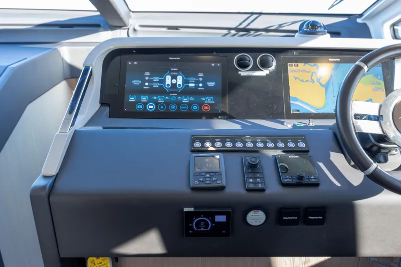Slide: The Image of Control panel of 2021 Azimut Fly 72 yacht with navigation screens and steering wheel. - 51