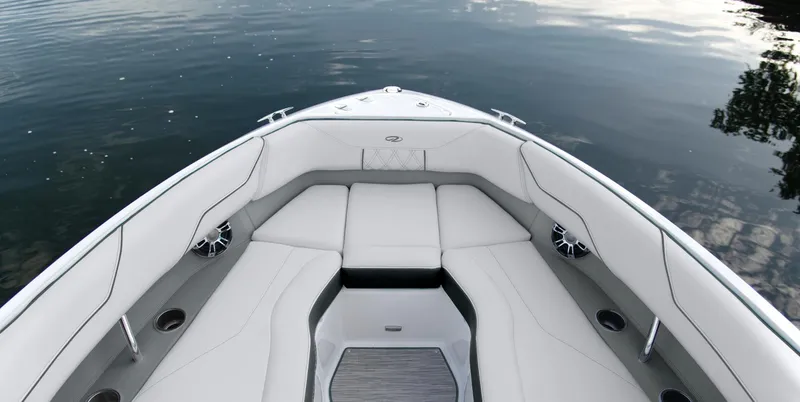 Slide: The Image of 2025 Regal LS4 boat interior with white seating on calm water. - 2