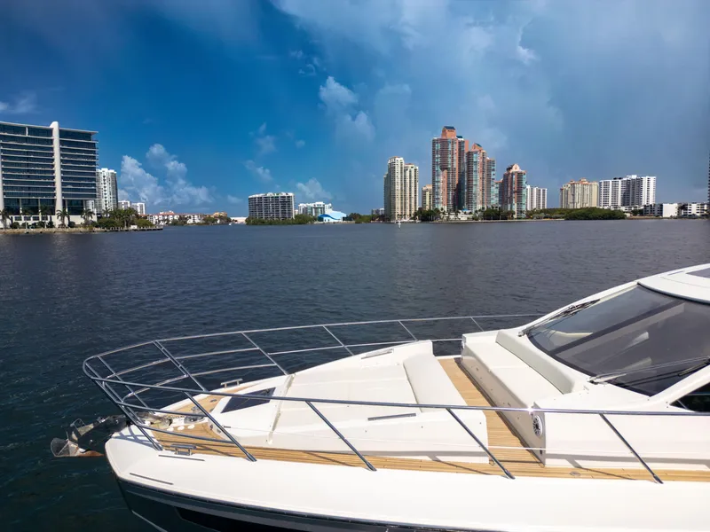 Slide: The Image of 2016 Azimut 55S yacht on water with city skyline in background. - 14