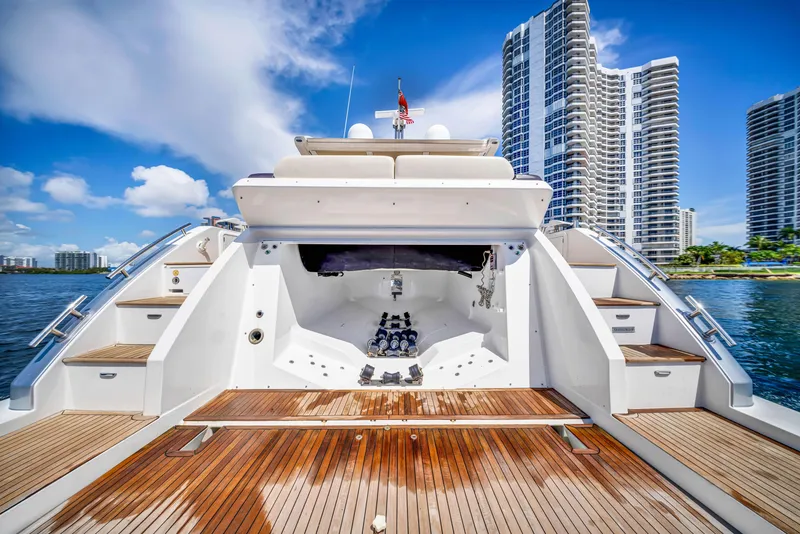 Slide: The Image of 2016 Azimut 55S yacht with wooden deck, city skyline in background. - 19