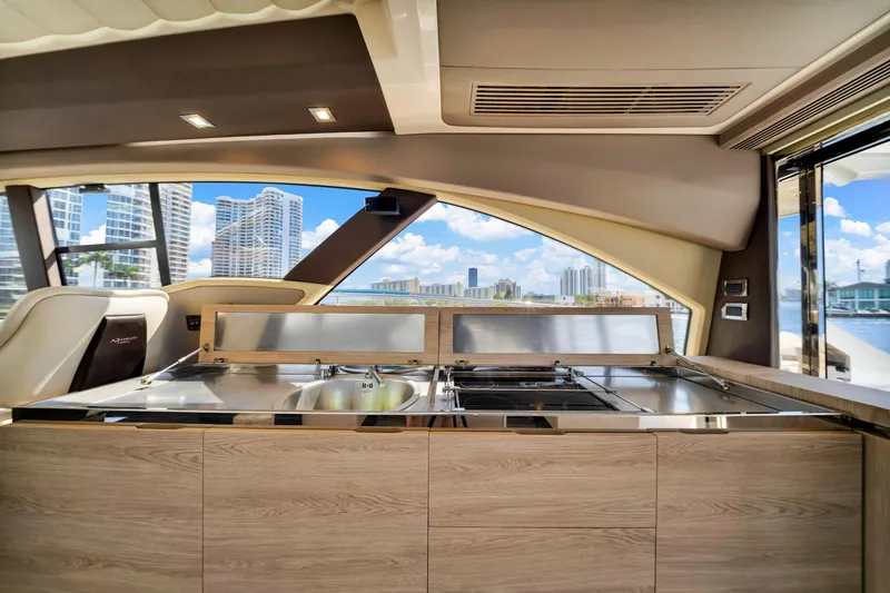 Slide: The Image of Interior view of 2016 Azimut 55S yacht kitchen with cityscape background. - 31