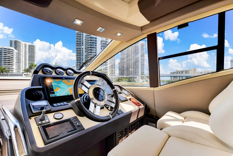 Slide: The Image of Luxurious 2016 Azimut 55S yacht helm with modern controls and city skyline view. - 39