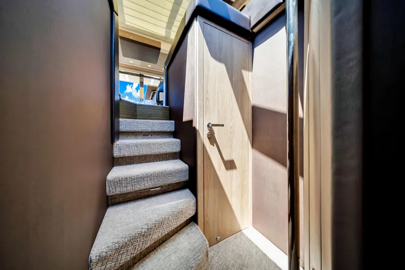 Slide: The Image of Staircase inside 2016 Azimut 55S yacht with modern design and wooden accents. - 43