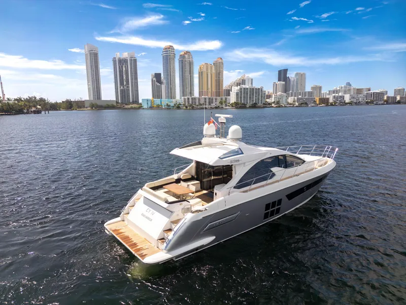 Slide: The Image of 2016 Azimut 55S yacht cruising near city skyline under clear blue sky. - 8