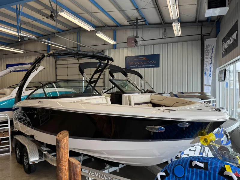 The Image of 2025 Regal LS2 boat in showroom, black and white design, on trailer. - 1