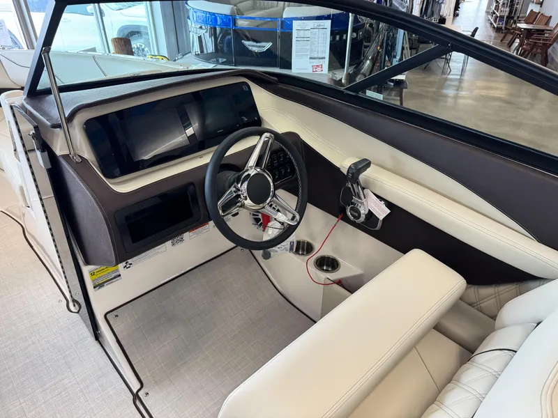 Slide: The Image of Interior of a 2025 Regal LS2 boat featuring a modern steering wheel and dashboard. - 10