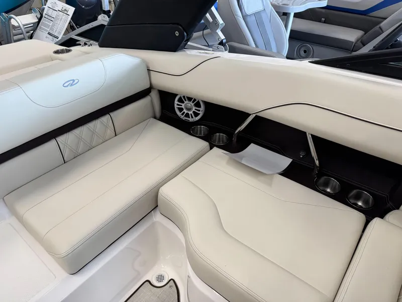 Slide: The Image of 2025 Regal LS2 boat interior with white leather seating and cup holders. - 12