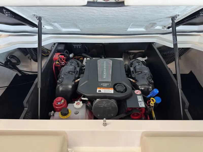 Slide: The Image of 2025 Regal LS2 boat engine compartment with dual engines and visible components. - 14