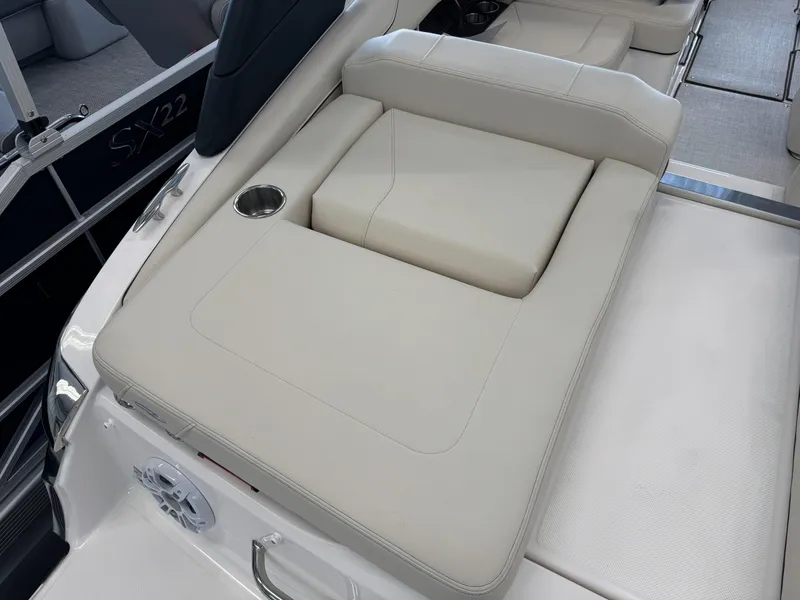 Slide: The Image of 2025 Regal LS2 boat interior with beige seating and cup holder. - 15