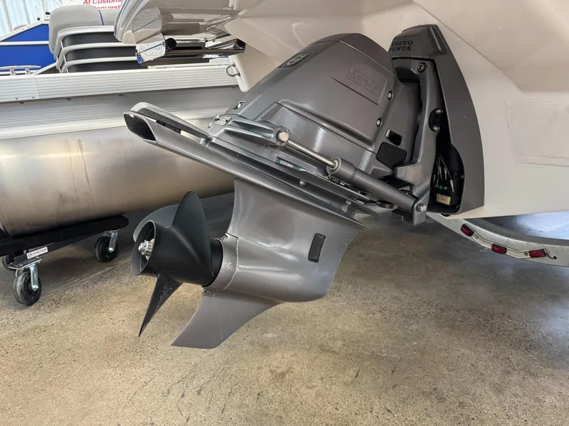 Slide: The Image of 2025 Regal LS2 boat outboard motor and propeller on display in a showroom. - 18