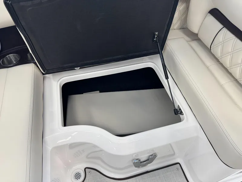Slide: The Image of Open storage compartment in 2025 Regal LS2 boat with white seating. - 6