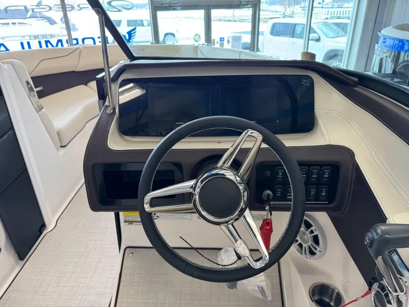 Slide: The Image of 2025 Regal LS2 boat dashboard with steering wheel and control panel. - 9