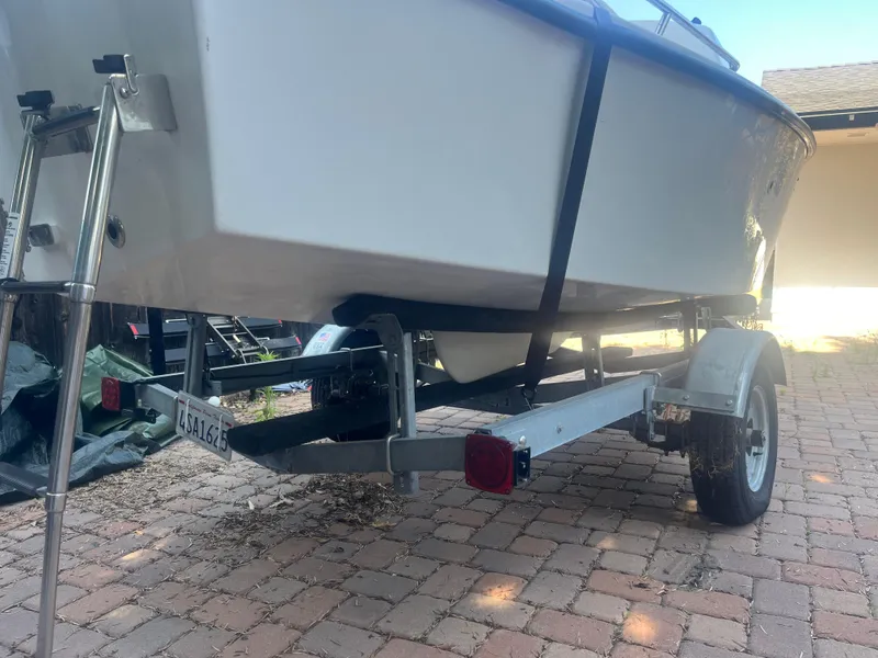 Slide: The Image of 2023 Malbec 18 boat on trailer, parked on brick driveway. - 11