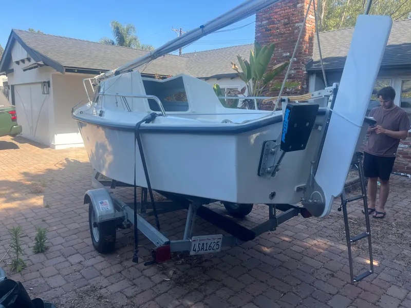Slide: The Image of 2023 Malbec 18 sailboat on trailer in residential driveway. - 12