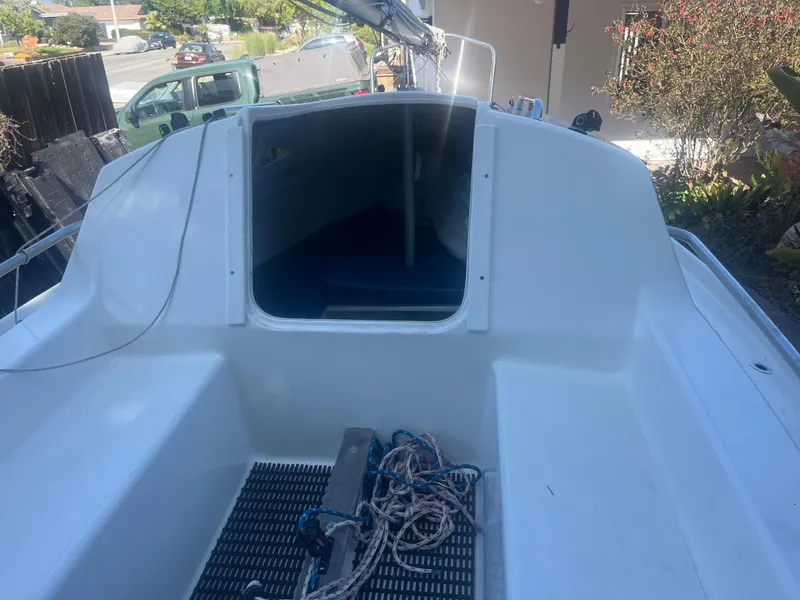 Slide: The Image of 2023 Malbec 18 sailboat cockpit with open cabin entrance and coiled ropes. - 3