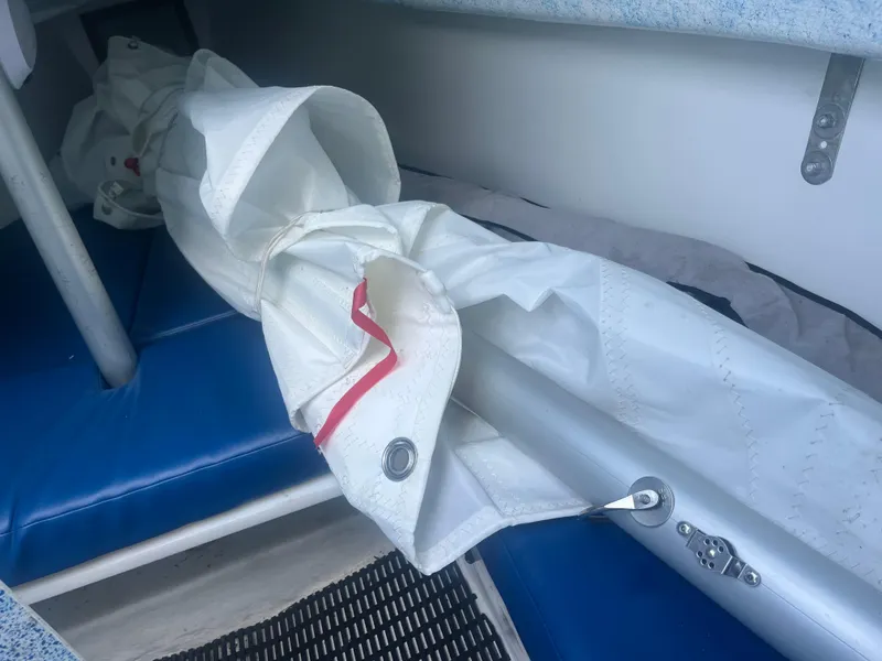 Slide: The Image of Rolled sail and mast inside a Malbec 18 sailboat, 2023 model. - 6