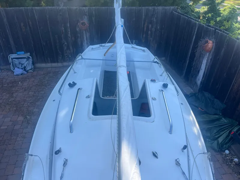 Slide: The Image of 2023 Malbec 18 sailboat in a fenced yard, viewed from above. - 8