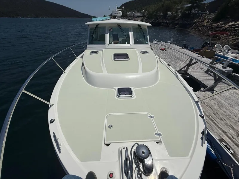 Slide: The Image of 2019 Back Cove Downeast boat docked by a scenic waterfront. - 10