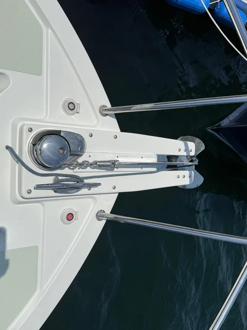 Slide: The Image of 2019 Back Cove Downeast boat bow with anchor and railing over water. - 12